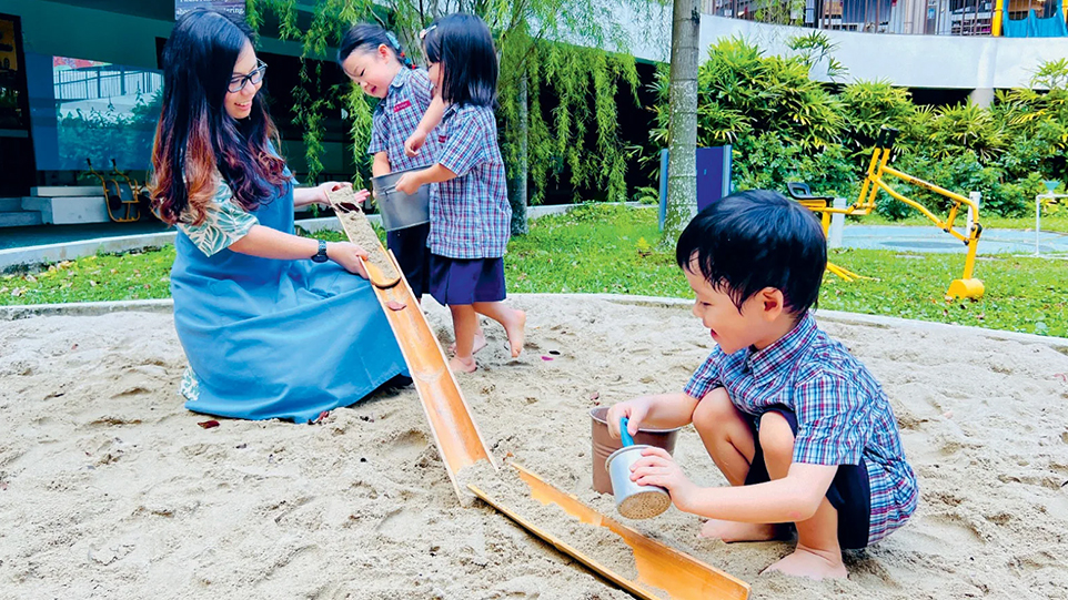 Children engage in open-ended play at the sand pit.