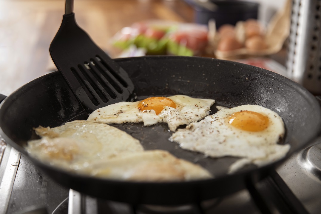 High Angle Delicious Eggs Pan ooking eggs on a Frying pan